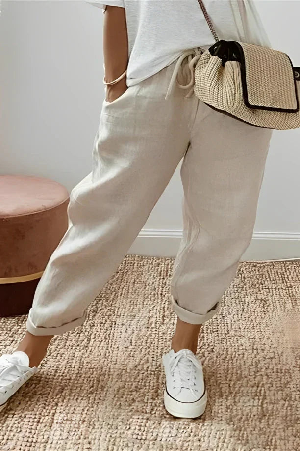 Plain-colored trousers with drawstring and slanted pocket